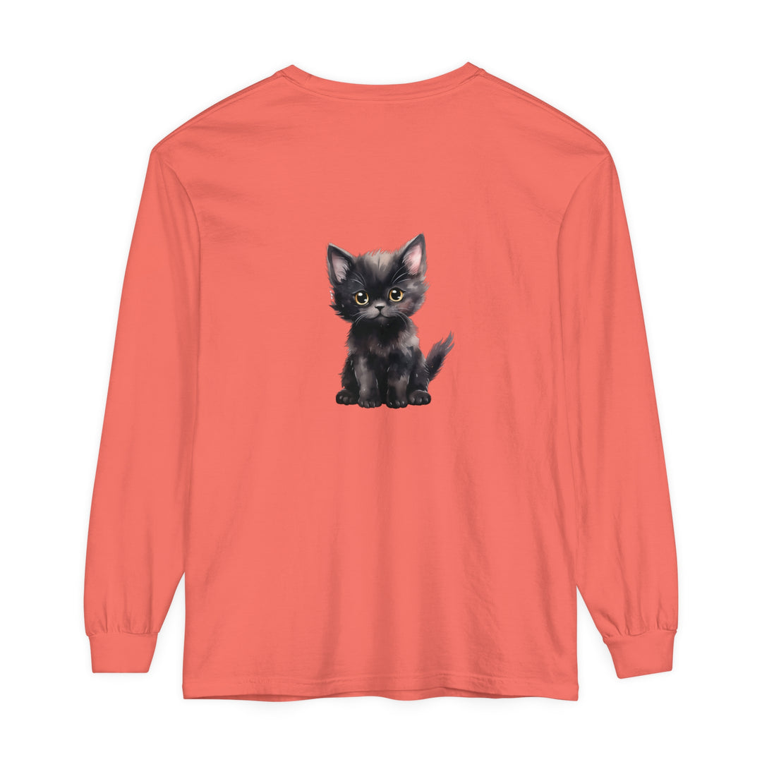 A cute black kitten with vibrant yellow eyes lounging on a long sleeve t-shirt