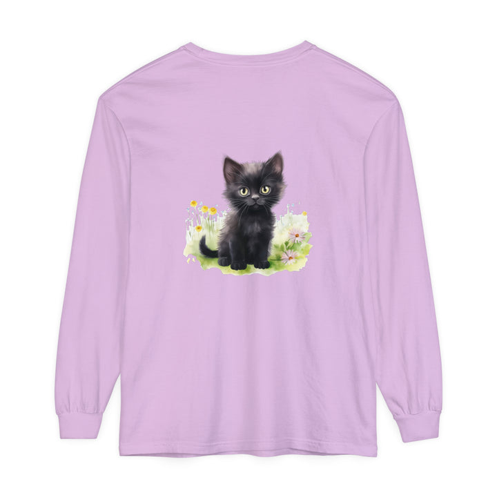 Black kitten sitting in a vibrant flower garden on a long sleeve t-shirt