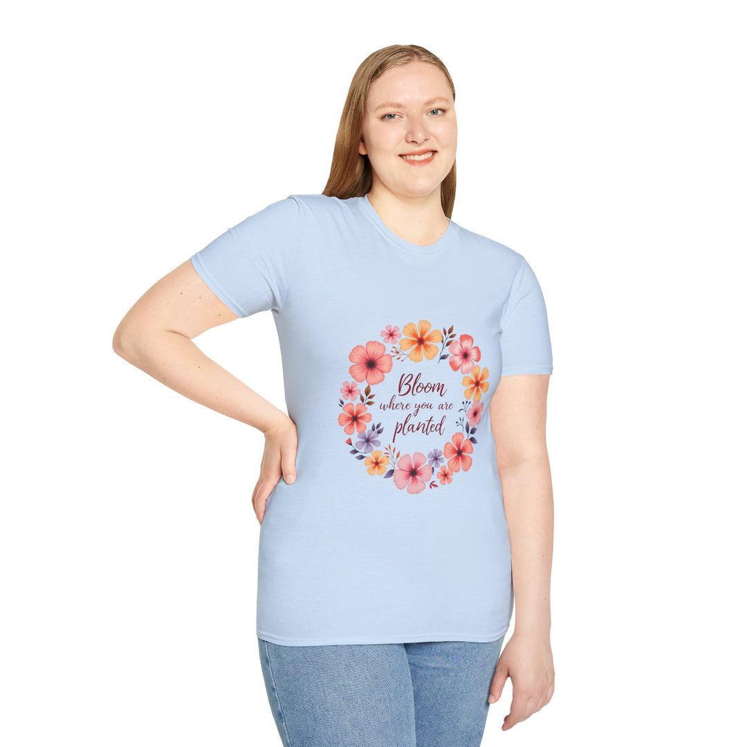 A white t-shirt with a vibrant floral mandala design and a quote in the center that says Be kind to yourself and others is displayed on a hanger