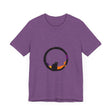 A black cat with glowing green eyes stands in front of a full moon, wearing a mysterious and stylish t-shirt with a spooky design