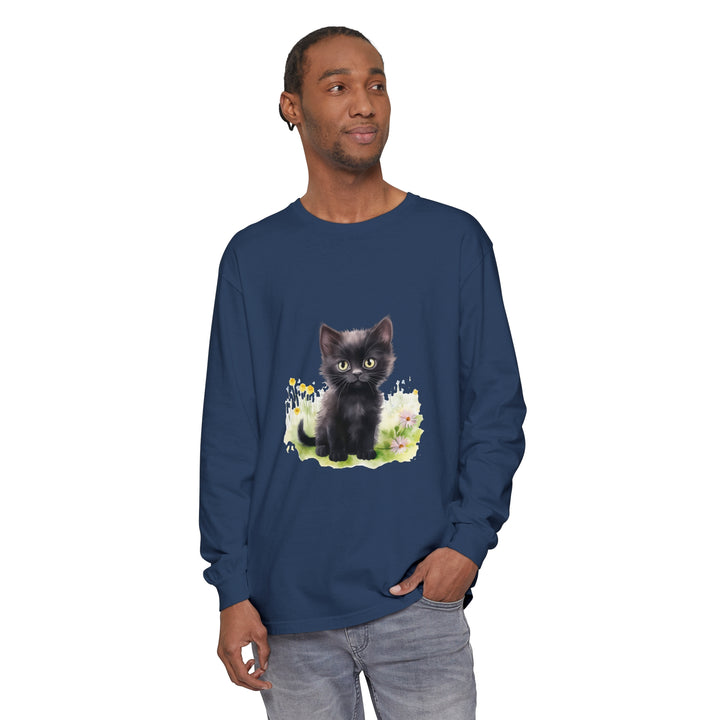 A cute black kitten explores a colorful flower garden on a long sleeve t-shirt