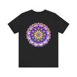 A close-up of a white t-shirt with a colorful mandala design, symbolizing spiritual peace and harmony