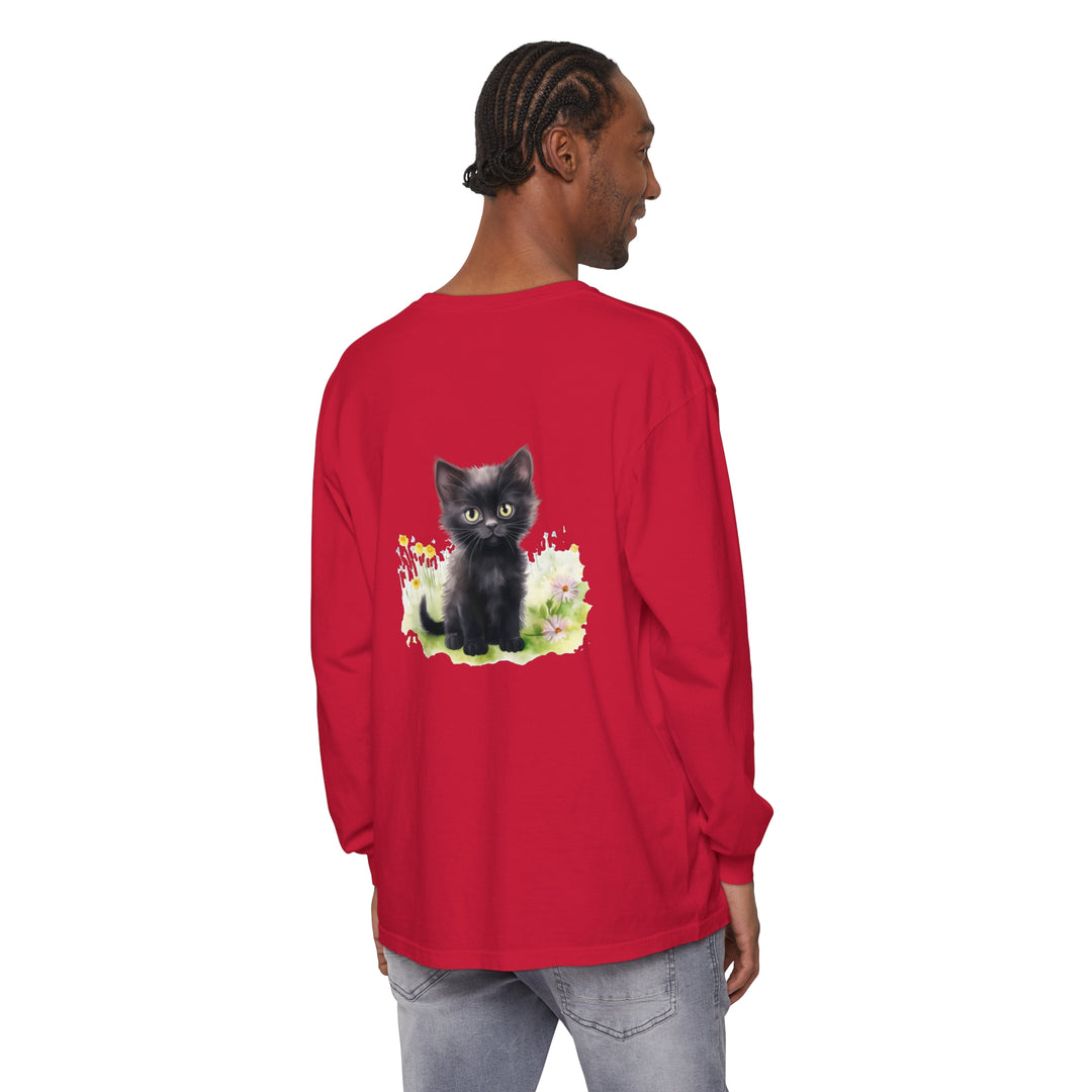 Adorable black kitten sitting amongst colorful flowers on a long sleeve t-shirt