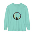 A stylish black cat sitting on a crescent moon against a Halloween-themed background, featured on a comfortable and festive T-shirt