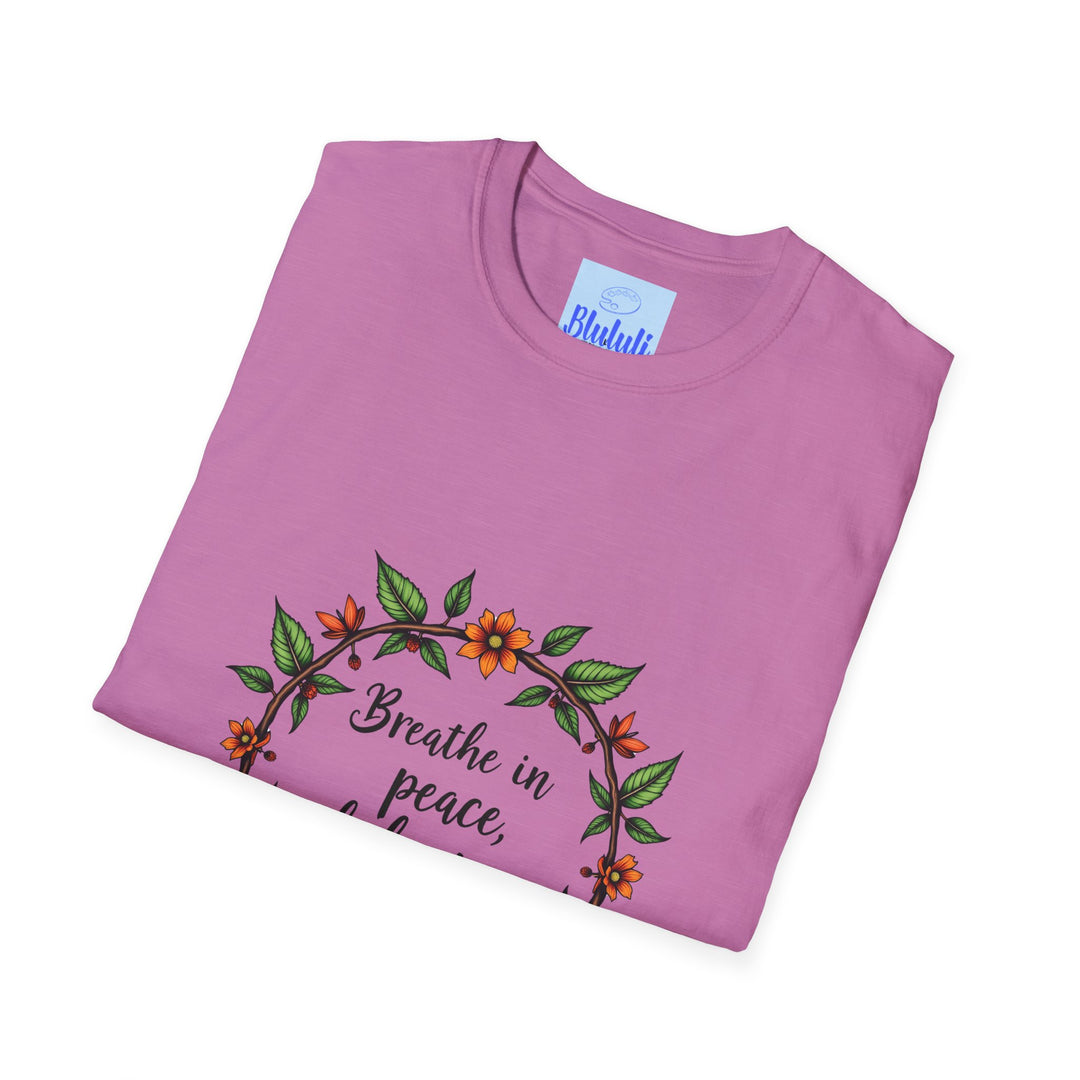 A close-up image of a white t-shirt with a colorful floral garland design and the text Breathe in Peace Exhale Stress printed on it