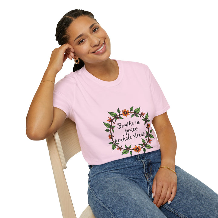 A close-up image of a white t-shirt with a floral garland design and the text Breathe in Peace Exhale Stress printed on it, symbolizing relaxation and tranquility