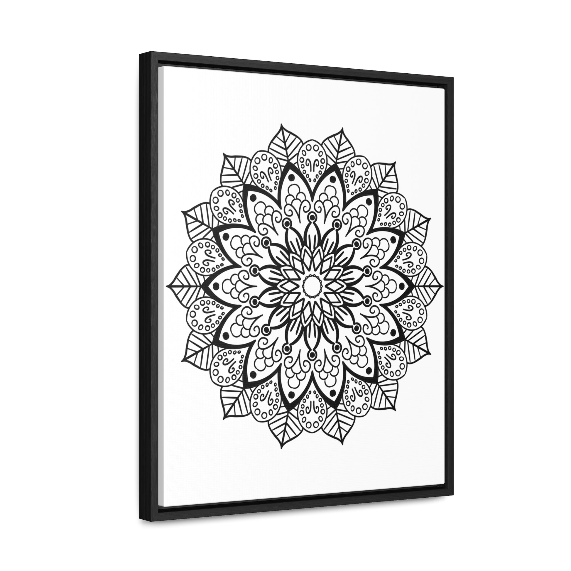 Handmade black and white mandala art on gallery canvas wraps, displayed in a vertical frame on a wall