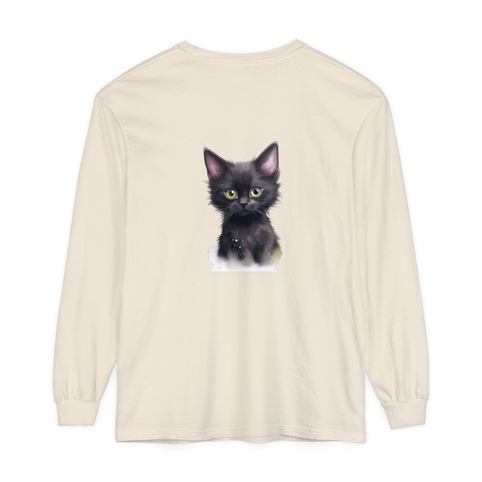 A black kitten with piercing green eyes sitting on a t-shirt