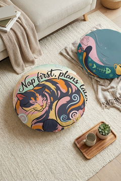 Round cat floor pillow in teal and pinks featuring a plump cat in Ukiyo-e rhythm, lifestyle setting for a cozy reading nook; close-up of flat color planes and bold lines