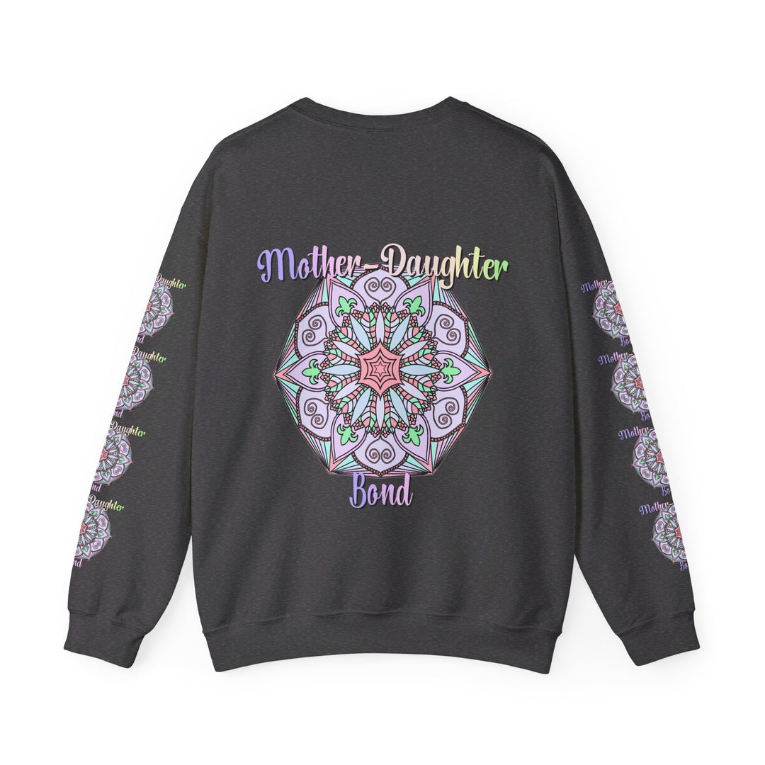 Mother and daughter sitting together, wearing matching 'Mother-Daughter Bond' Unisex Heavy Blend™ Crewneck Sweatshirts, the perfect birthday gift for Mom