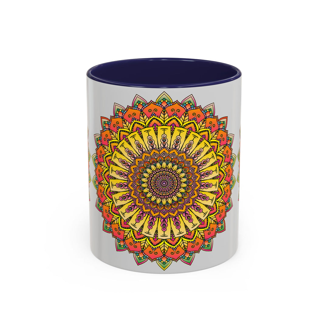 A grey mug with a vibrant mandala design in various colors