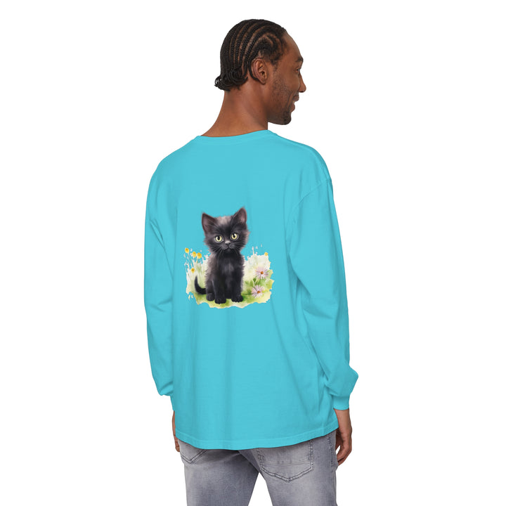 A cute black kitten surrounded by colorful flowers on a long sleeve t-shirt