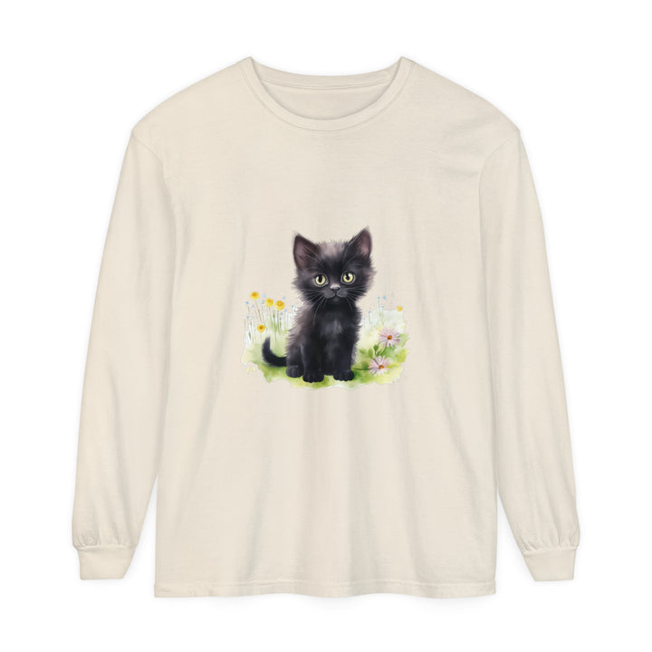 A cute black kitten sits surrounded by vibrant flowers on a long sleeve t-shirt