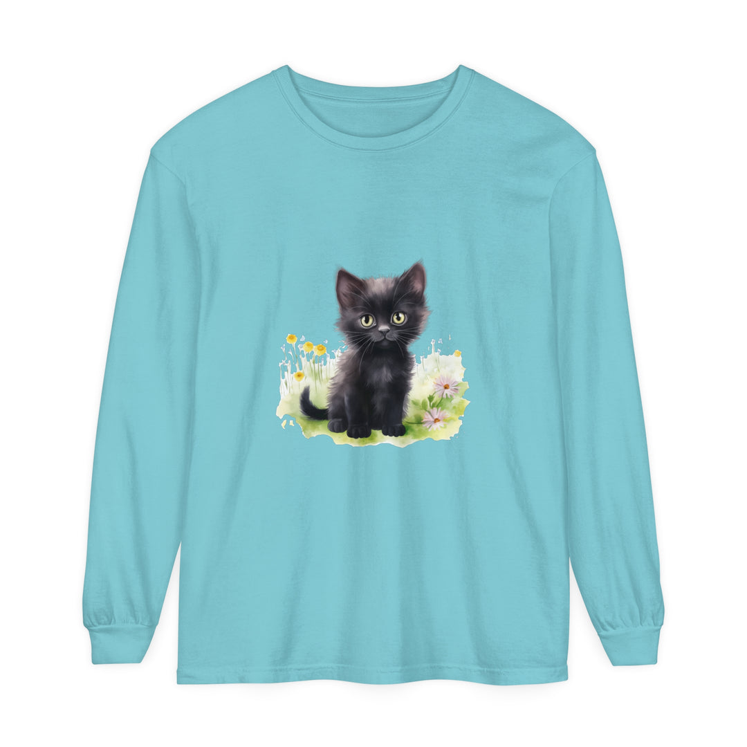 Adorable black kitten sitting in a vibrant flower garden, printed on a long sleeve t-shirt