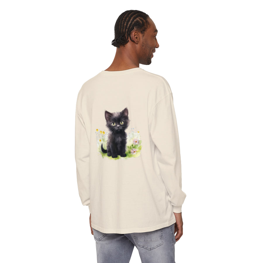 Adorable black kitten sitting in a colorful flower garden on a long sleeve t-shirt