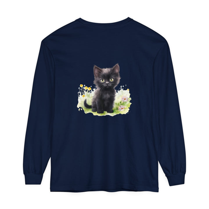 A playful black kitten sits among colorful flowers in a garden, featured on a stylish long sleeve t-shirt