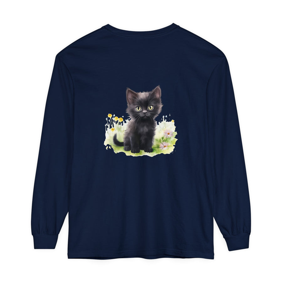 A playful black kitten sits among colorful flowers in a garden, featured on a stylish long sleeve t-shirt