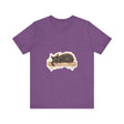 A watercolor illustration of a black cat sleeping peacefully on a t-shirt