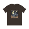 A comfortable black t-shirt with a sleepy cat design under a moonlit night