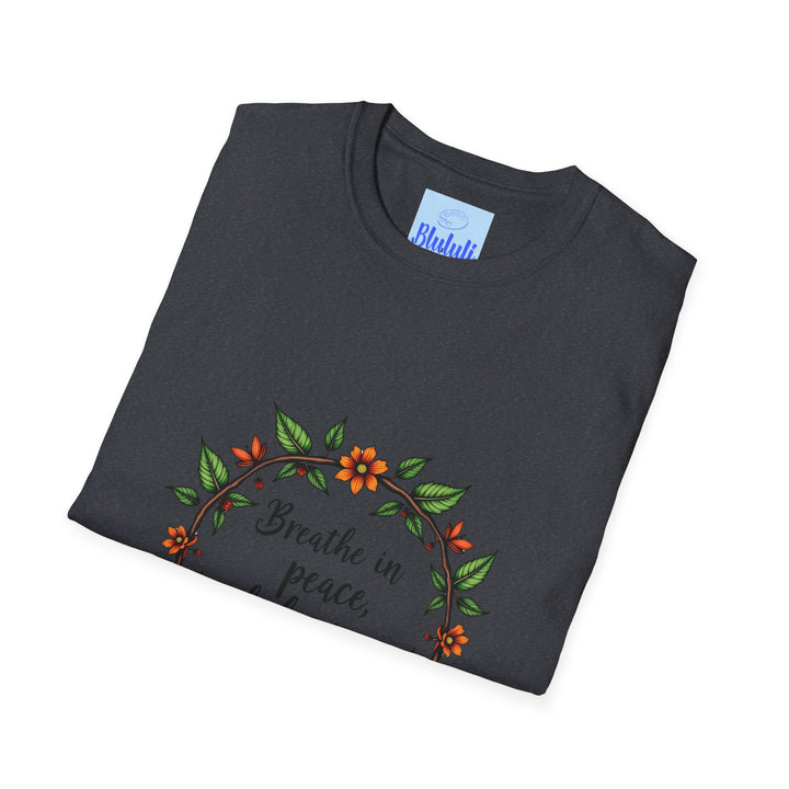 A close-up image of a white t-shirt with a floral garland design and the text Breathe in Peace Exhale Stress in elegant script font, perfect for adding a touch of tranquility to your wardrobe