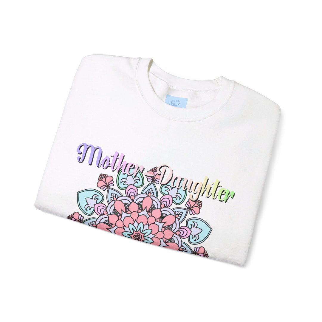 Mother and daughter standing arm in arm, smiling, wearing matching 'Mother-Daughter Bond' Unisex Heavy Blend™ Crewneck Sweatshirts, the perfect birthday gift for Mom