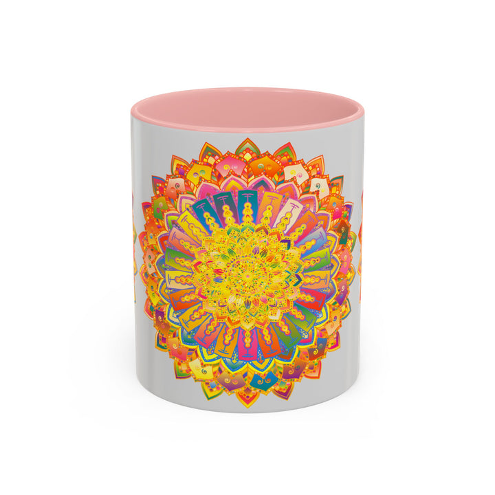 A vibrant and colorful mandala design adorns a grey mug, creating a stunning and eye-catching piece of art