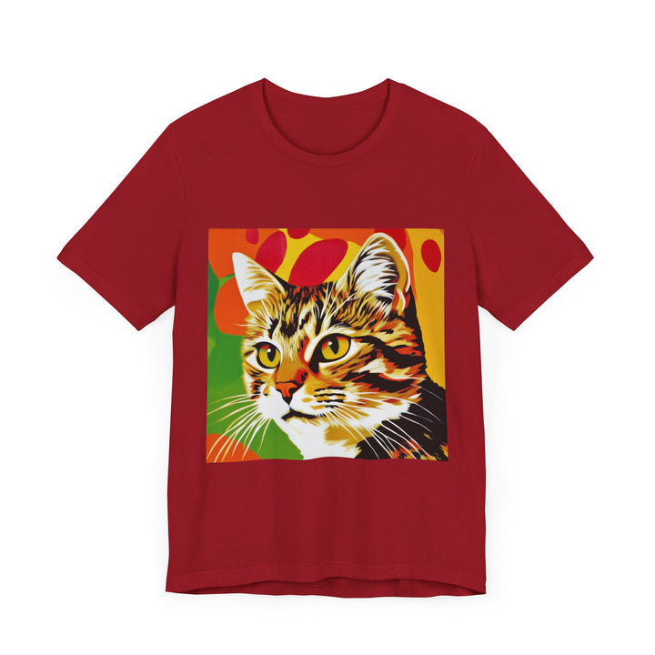 A colorful and vibrant short sleeve tee featuring a pop art style illustration of a tabby cat