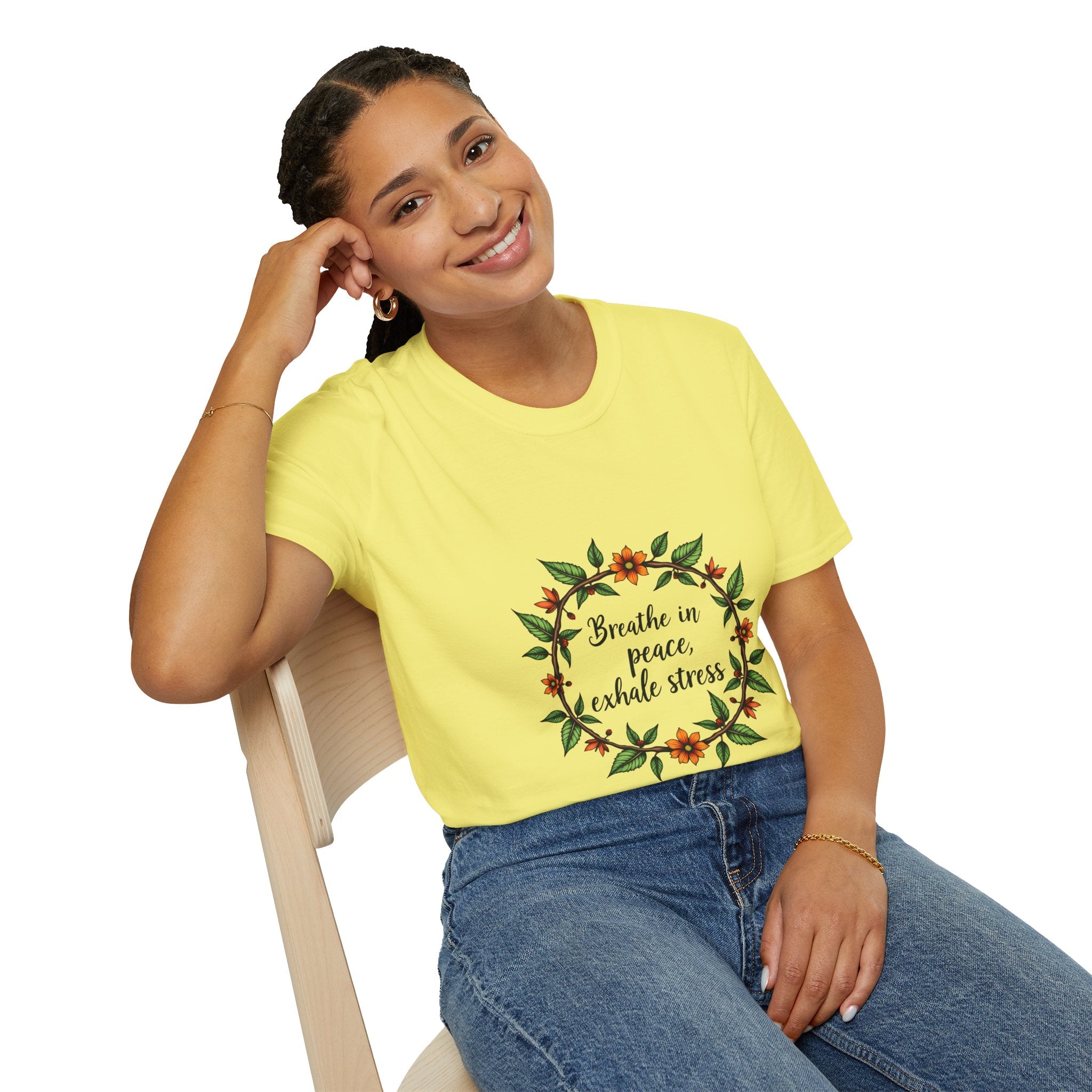 A close-up image of a white t-shirt with a delicate floral garland design, accompanied by the text Breathe in Peace Exhale Stress in stylish lettering