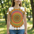 Lifestyle photo of a woman wearing a warm sunset hues mandala t-shirt, outdoors, casual and relaxed, close-up on the vibrant mandala print and comfortable fit