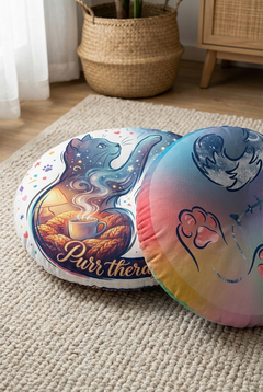 Dark blue #002A5C cat round floor pillow with double-exposure Cozy Winter Cute Cat design, lifestyle close-up shot showing a curled silhouette and two worlds (warm interior and snowy night), vibrant colors, textured tufted surface