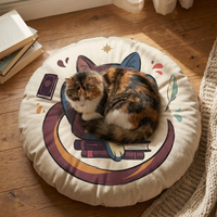 Round floor pillow featuring a Winter Cozy Dark Academia cat design in plum, gold, and coral hues; lifestyle close-up in a cozy study nook with books and quill, showcasing a cat-friendly, comfortable seating accessory.