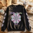Black sweatshirt with 'Mother-Daughter Bond' design on a wooden surface with decor items.