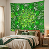 A large green wall tapestry featuring a detailed mandala and shamrock pattern, hanging on a bedroom wall above a bed with neutral-toned bedding.
