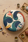 Winter 2026 New Year Cozy Cat floor pillow, round tufted cushion in teal and warm accent colors, lifestyle scene next to a sofa with a small table, shot at 15-25 degrees from above