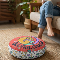 Round Cozy Curl Cat Floor Pillow featuring warm coral and mint tones, winter cat design, lifestyle close-up in a living room setting with soft textures. 
