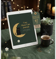 A tablet on a green fabric tablecloth displaying a digital journal cover titled 'Cozy Moon Cats Journal' with a black cat on a crescent moon. A hanging tag reads 'DIGITAL PDF DOWNLOAD $7 USD' and 'INSTANT ACCESS.