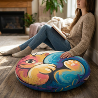 Round floor pillow with a curled hugging cat in vibrant colors; lifestyle shot showing a cozy, playful moment on a chair, oil-painting and cartoon-line art style, durable fabric in a living room setting.