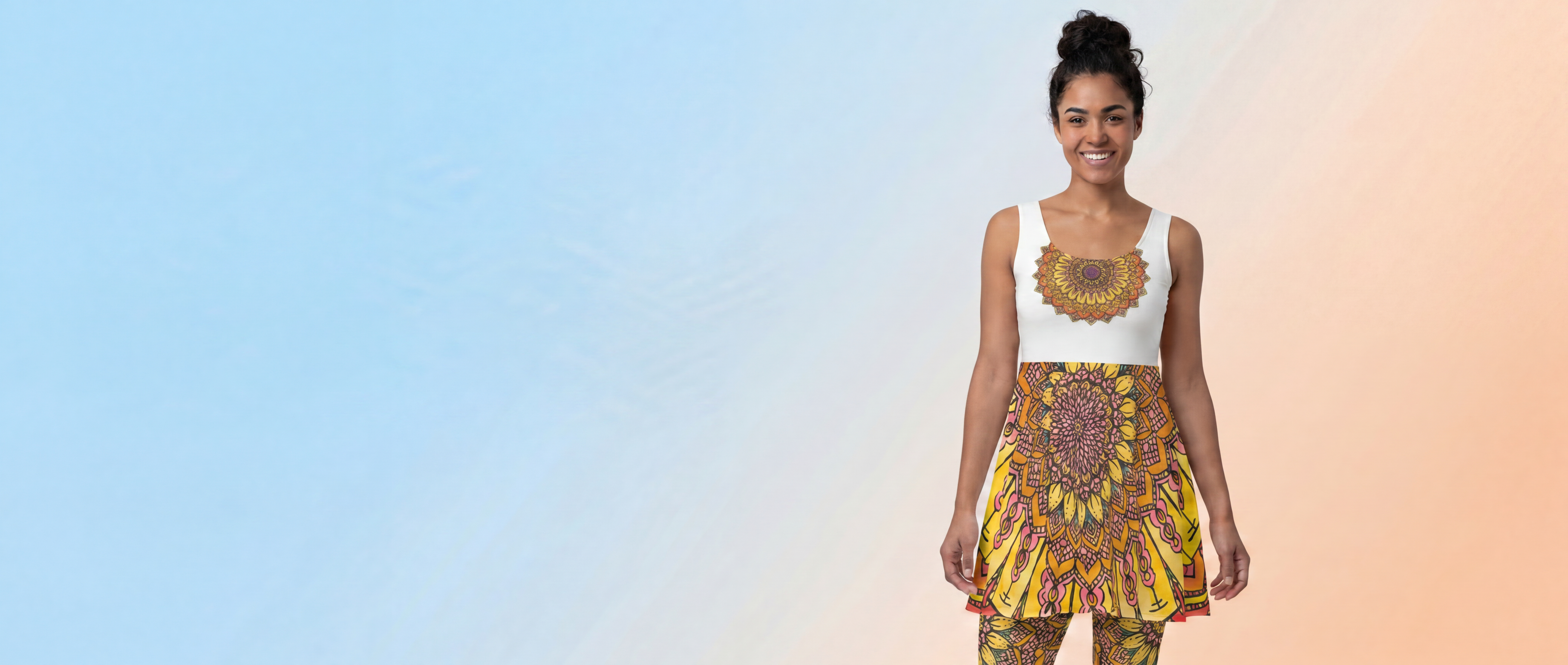Woman wearing a white sleeveless top with a sunflower design and colorful patterned pants on a gradient background