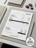 A printed invoice sheet laid on a light gray tablet sleeve, styled on a desk with a pen, laptop, and stones. A circular badge in the corner says 'Instant Download' with 'Minimal Design Instant Access.