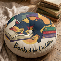 Close-up of a round tufted cat-themed floor pillow in dark academia colors (#102a43, #0b6e4f, #ffd166). A dark blue background with a curled cat over books, warm ochre accents, and a hint of calligraphic text; lifestyle close-up suitable for winter reading nook visuals.