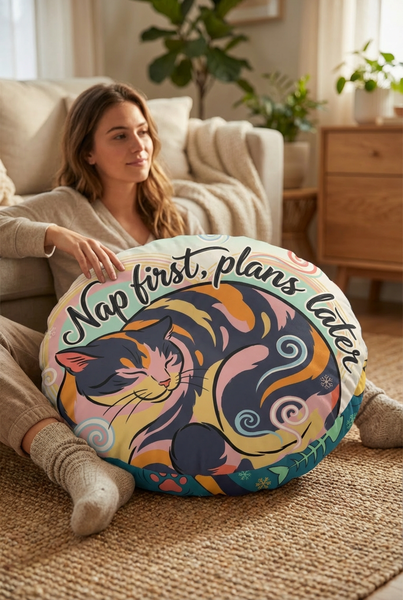 Winter cozy kitten in Ukiyo-e rhythm round floor pillow featuring teal and coral colors, lifestyle close-up in a reading nook with a cat-centered design and bold calligraphy, showing the pillow in use in a cozy living space.
