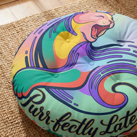 Close-up of a vibrant teal cat-themed round floor pillow with tufted texture and surreal crescent-cat motif; winter/post-New-Year whimsy vibe in a cozy living room setting, lifestyle shot showing a plush, comfortable ambiance.