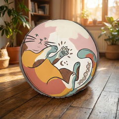 Round tufted cat floor cushion in warm boho colors with playful line-art cat design; living room lifestyle scene showing cozy, inviting atmosphere