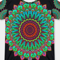Lifestyle close-up of a Mandala Art T-shirt with bold green and red mandala design, showing a tag-free collar and reinforced double-stitched hem for durability.