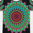 Lifestyle close-up of a Mandala Art T-shirt with bold green and red mandala design, showing a tag-free collar and reinforced double-stitched hem for durability.