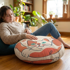 Round Boho Cat floor pillow in pink-red (#FF6B6B) with line-art cat design, Boho color palette, lifestyle setting (living room/reading nook), cozy decorative cushion for home decor.