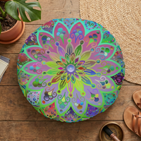 Lifestyle flatlay of a turquoise mandala floor cushion on a light surface, showcasing a hand-drawn, colorful round cushion with a double-sided print